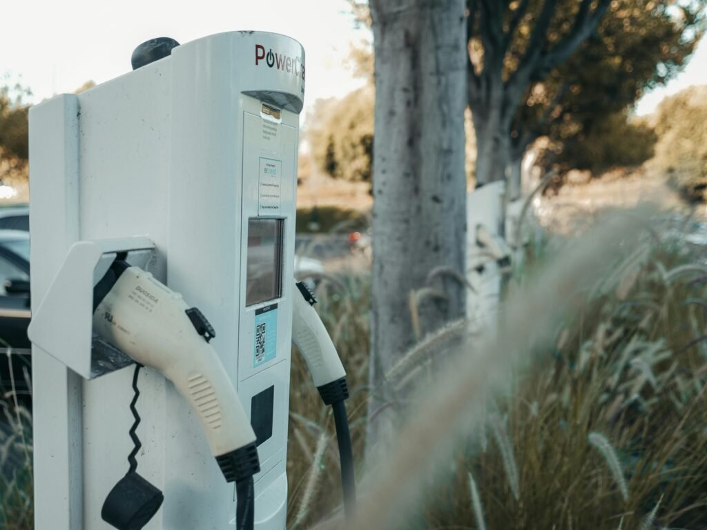 Electric vehicle charging station in an outdoor natural setting, highlighting sustainable technology.